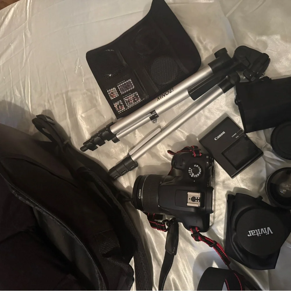 CANON EOS Rebel t100 with 18-55mm lens and another lens.
